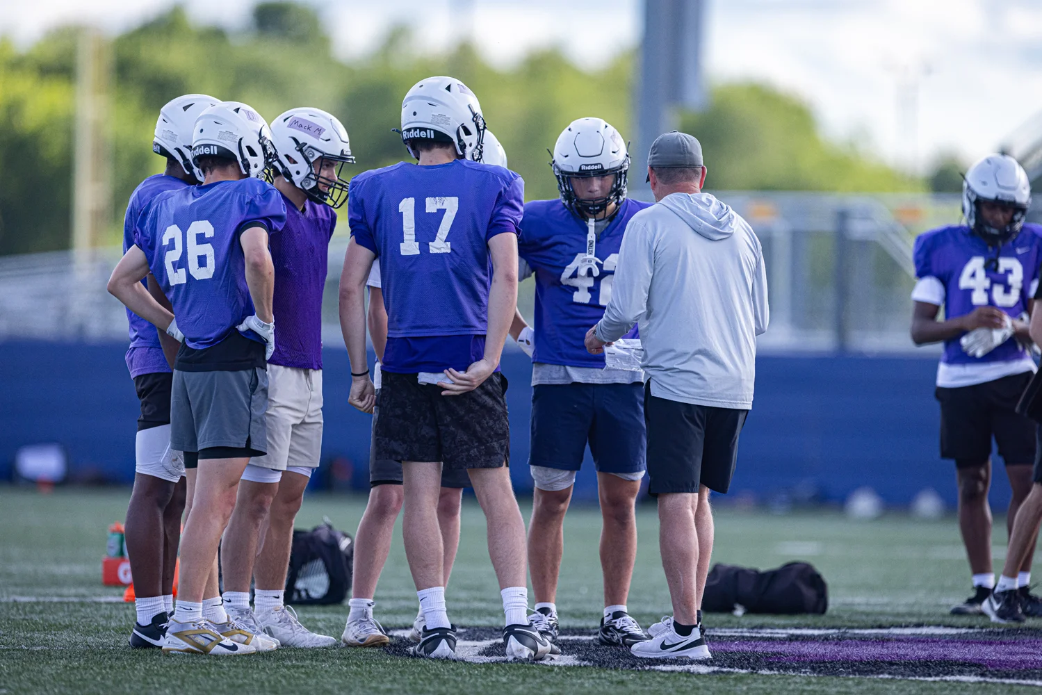 Bison Coach talking to the team in a huddle